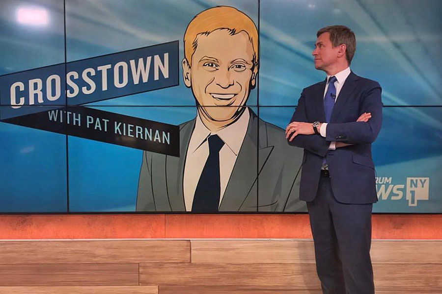 Pat Kiernan smiling at an animated image of himself. 