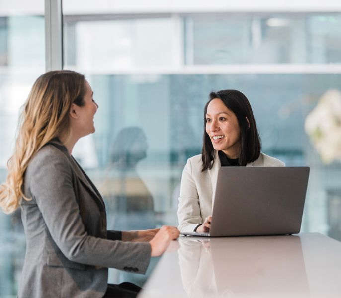 Two women collaborating in a Charter Communications office