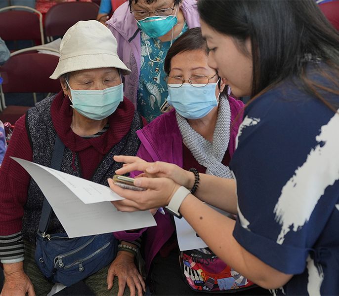 Group of Asian American women learning how to use their smart devices 